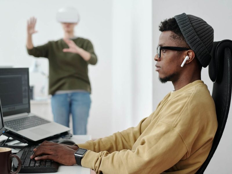 side view of young businessman decoding data while looking at computer screen.jpg