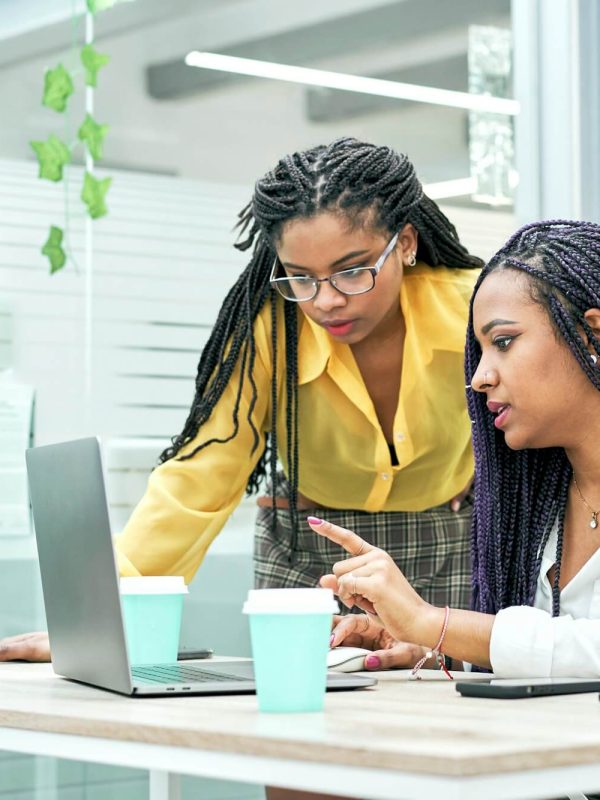 two young black women reviewing analytical data on various electronic devices .jpg