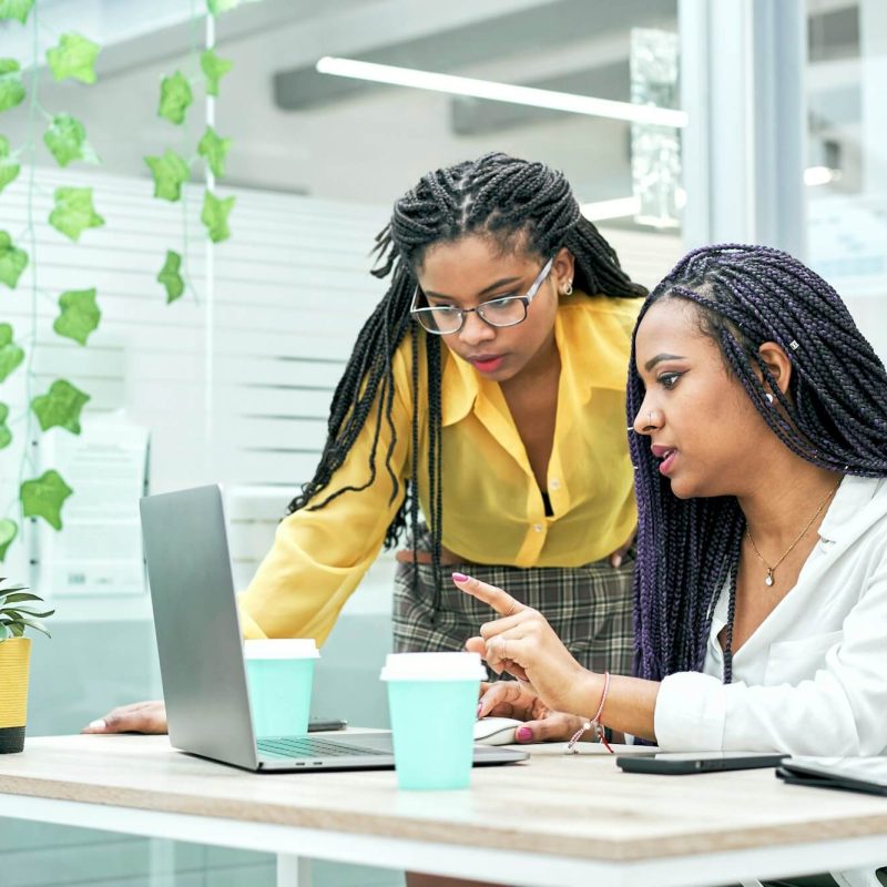 two young black women reviewing analytical data on various electronic devices .jpg